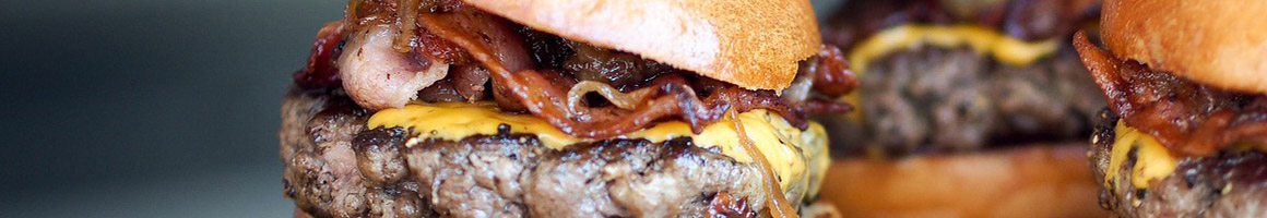 Eating Burger Deli Sandwich at Reuben's Deli restaurant in Atlanta, GA.